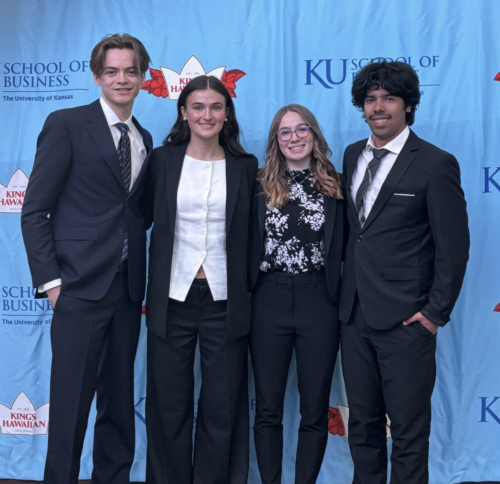 Four persons pose in business attire